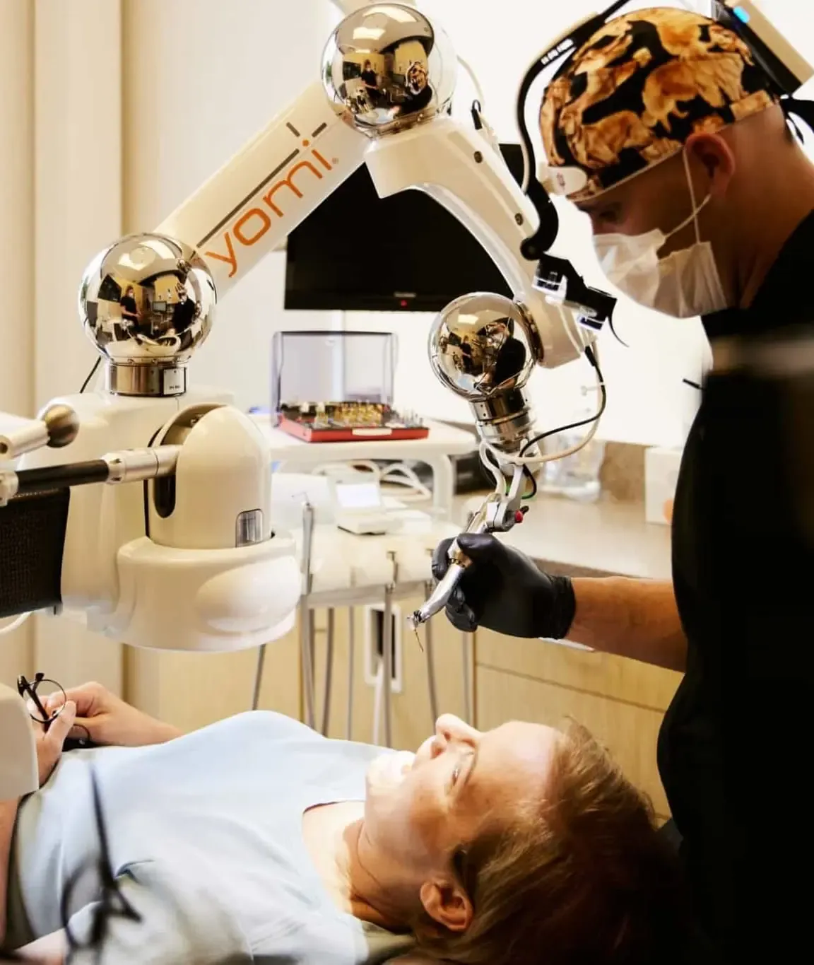 Dr. Bryce Richardson placing a dental implant with the Yomi robotic arm at Vivid Smiles Dentistry