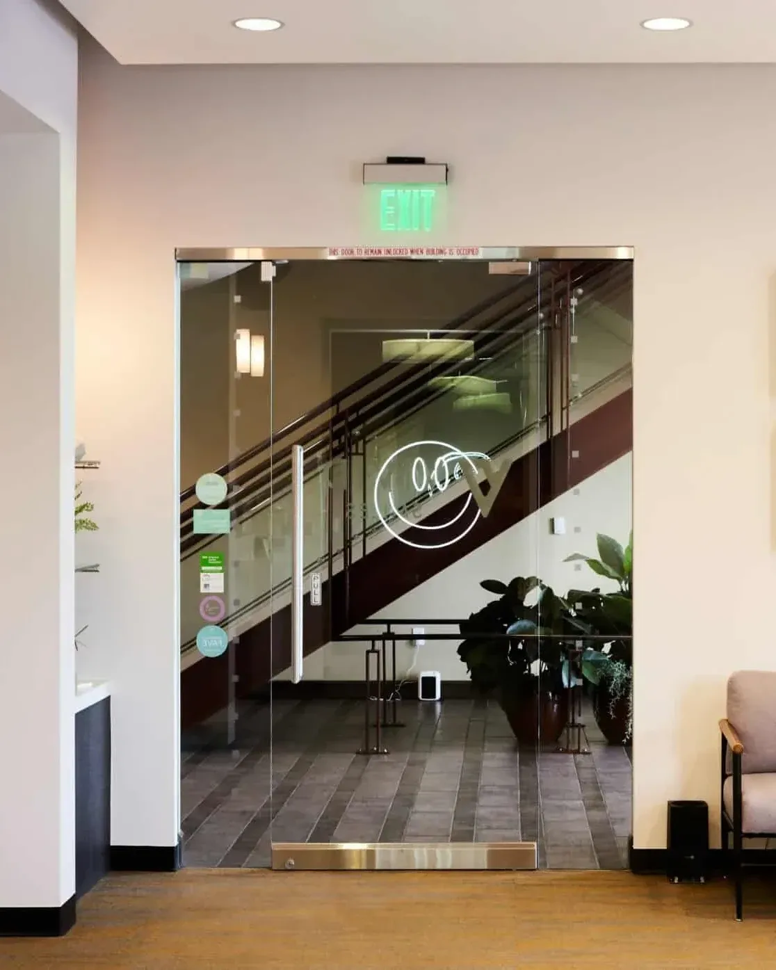 Entry doors at Vivid Smiles Dentistry in Parker, CO, etched with the practice logo