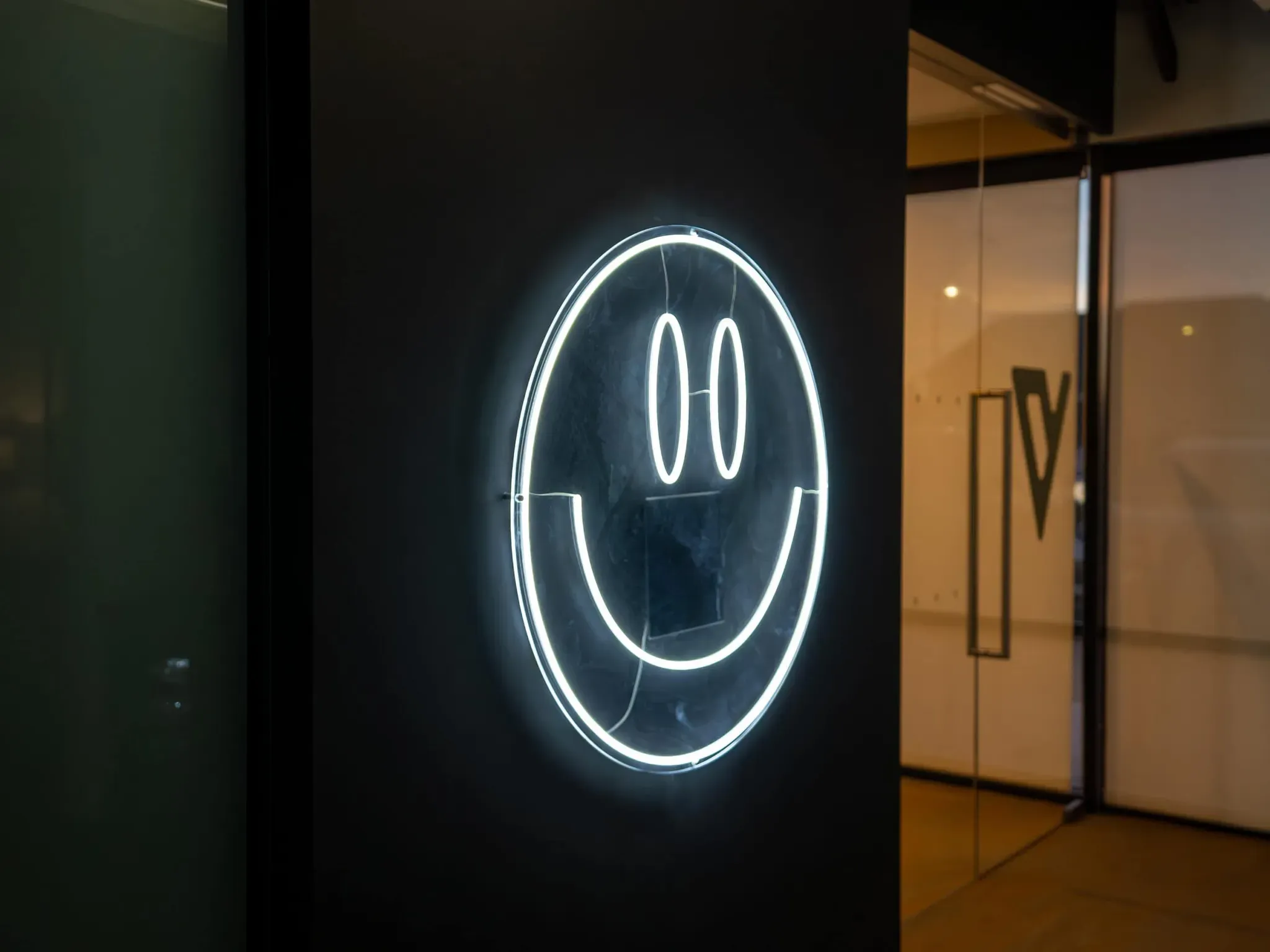 Neon Vivid Smiles sign glowing softly in the waiting lounge