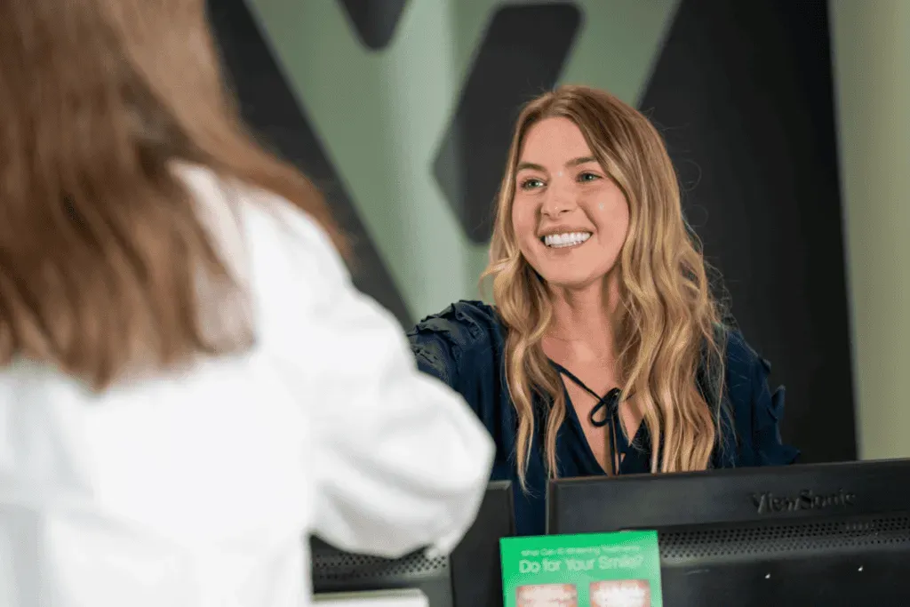 A patient checking in at the Vivid Smiles Dentistry front desk in Parker, CO