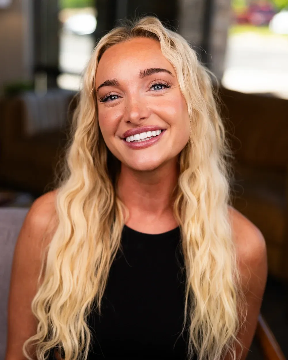 Smiling woman photographed in a warm interior setting