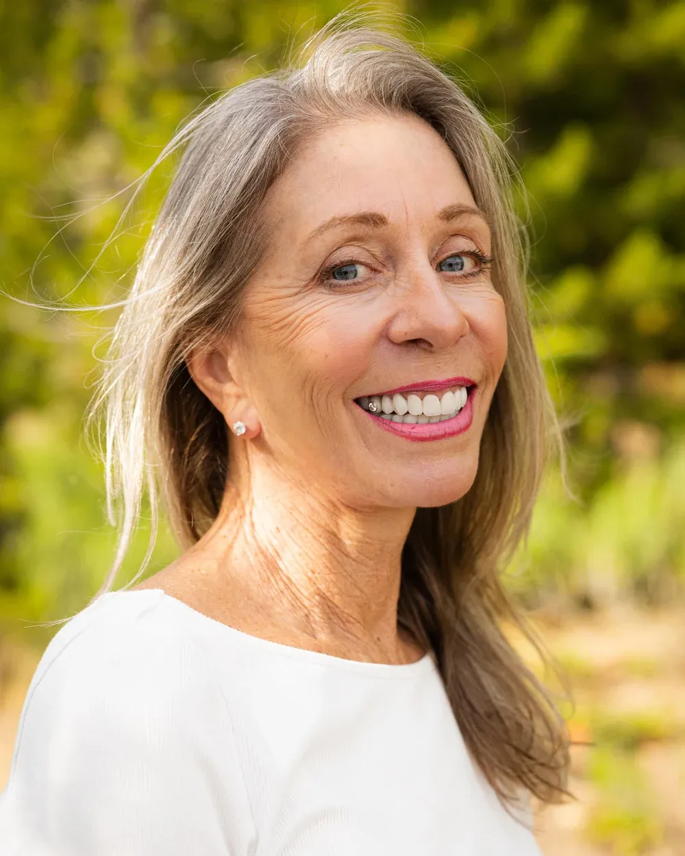 Smiling woman photographed outdoors in the Colorado foothills