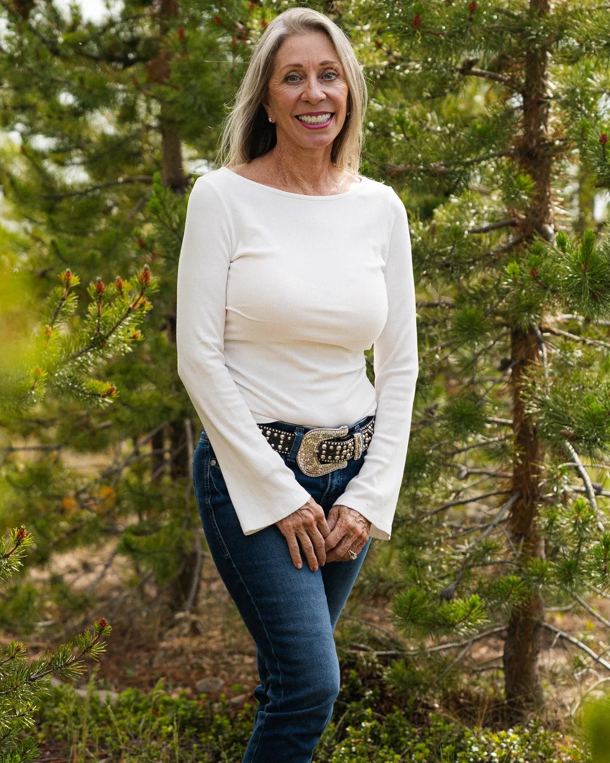 Smiling woman photographed outdoors among Colorado pines