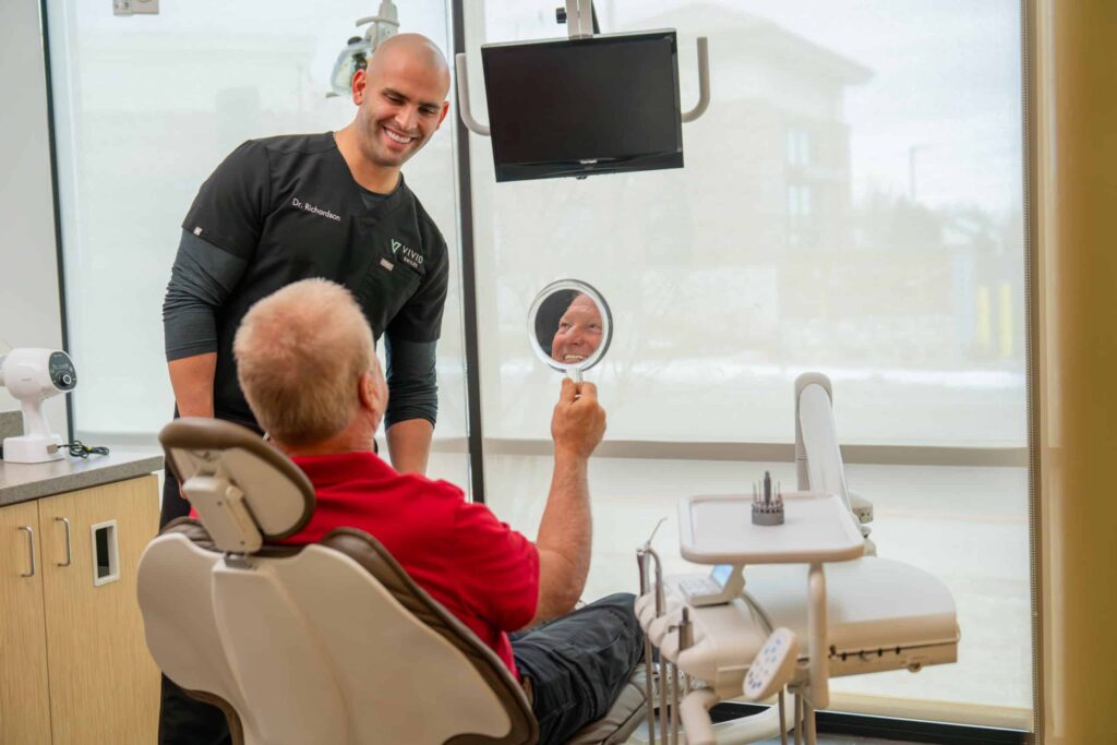 Dr Bryce Richardson with a patient following a dental procedural