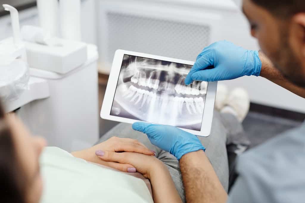 A doctor showing a patient their X-ray