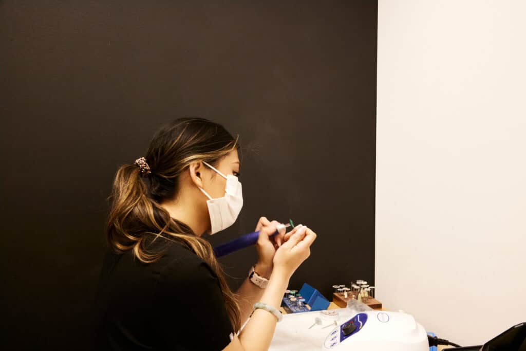 A Dental Lab Tech Working on a model of a tooth that will be used in a dental implant