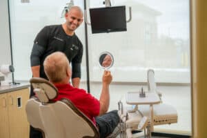 Dr Bryce Richardson with a patient smiling with their new smile