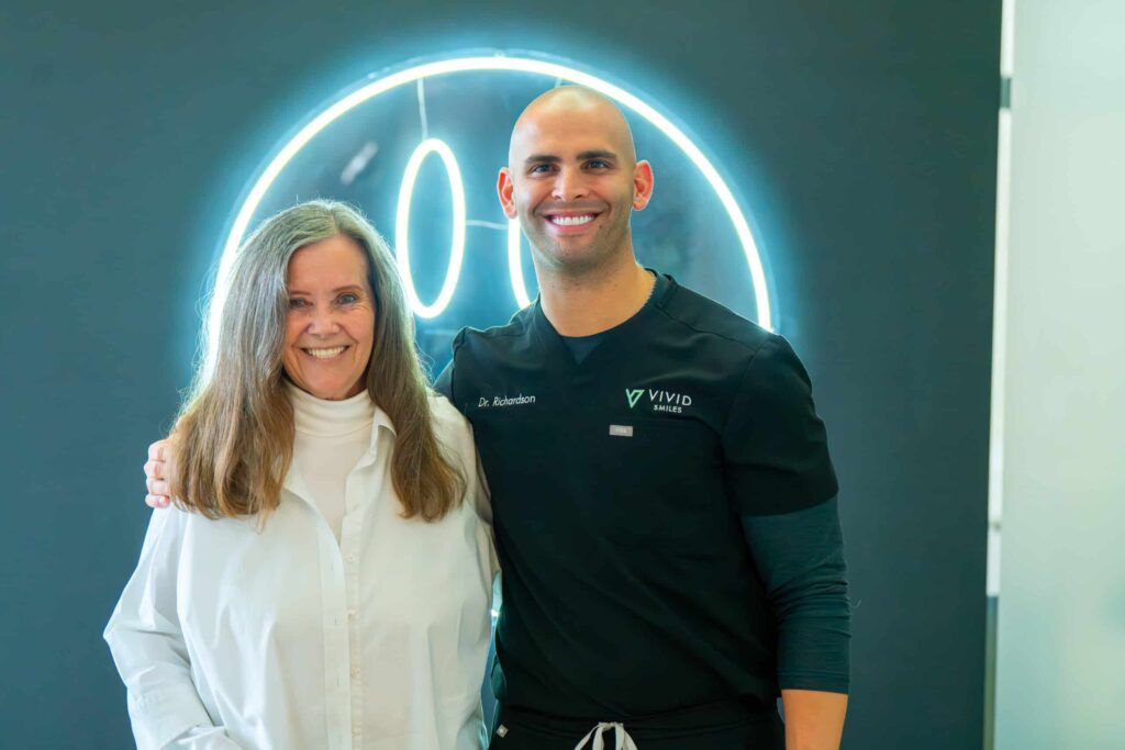 Dr Bryce posing with a patient after all-on-4 dental implants