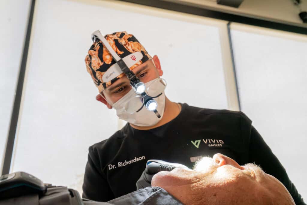 Dr Richardson preforming a dental cleaning on a patient