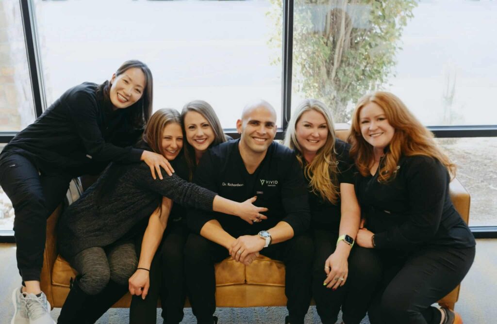 Dr. Bryce Richardson And Team On A Couch In The Waiting Room.