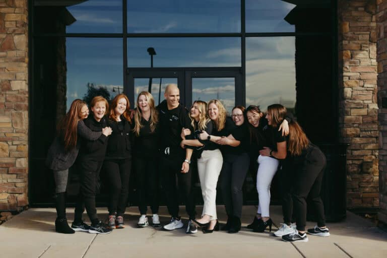 Dr Richardson and his staff posing for a photo just outside the office