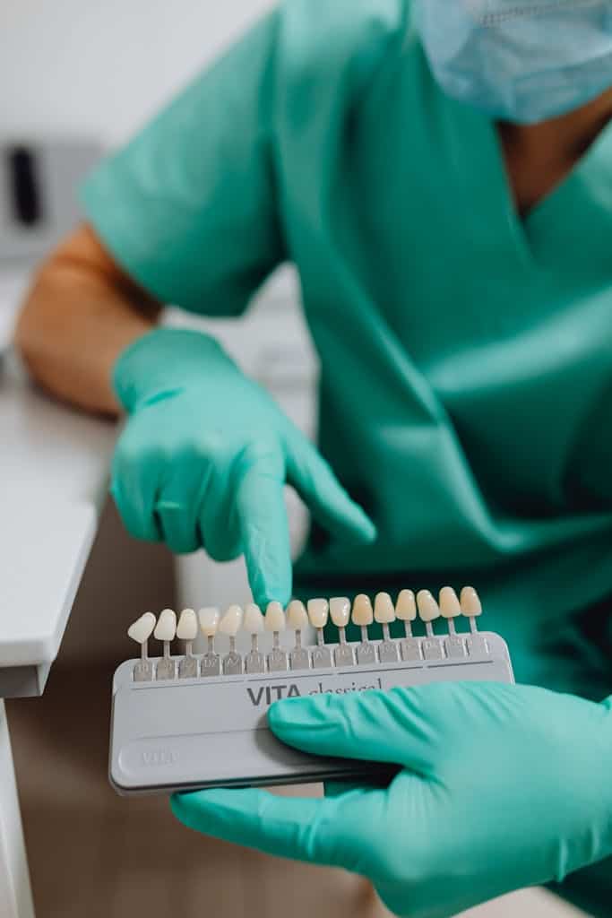 Hygienist with a tray of example veneer colors for a patient to pick from